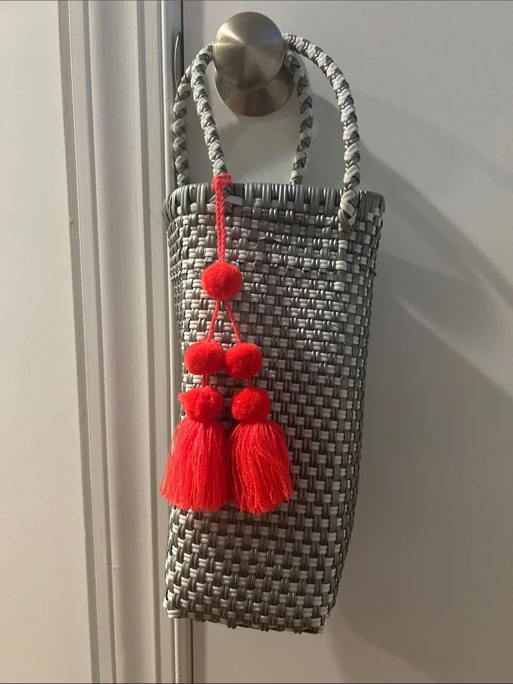 Woven Gray Tote Bag with Red Tassel Accent